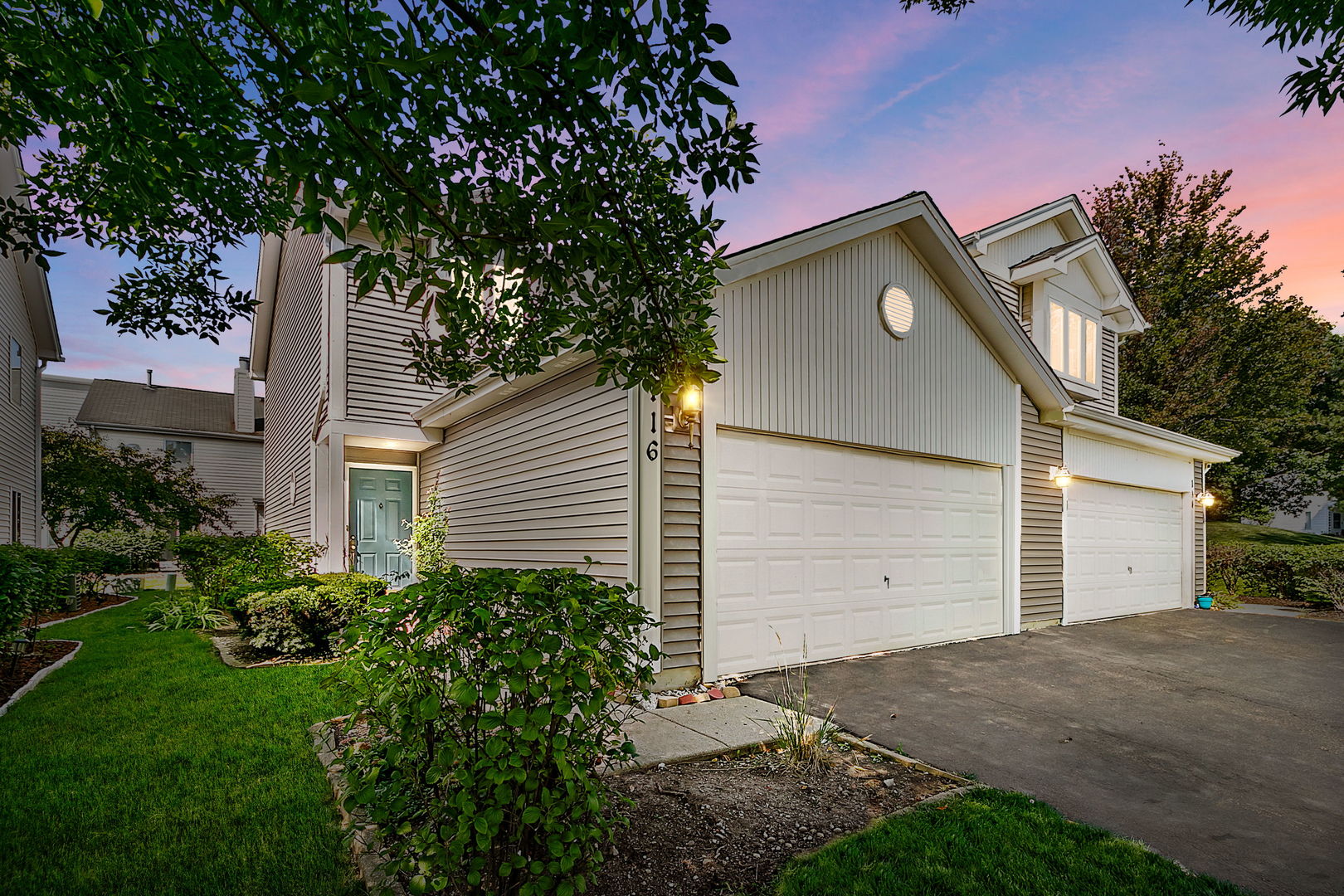 a front view of a house with a yard and garage