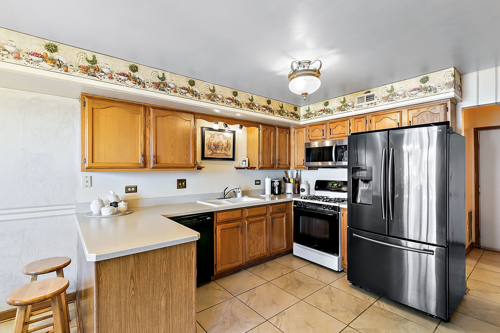 116 Hampton Avenue Westmont, IL 60559 - Photo 5 of 19 a kitchen with stainless steel appliances a refrigerator sink and cabinets