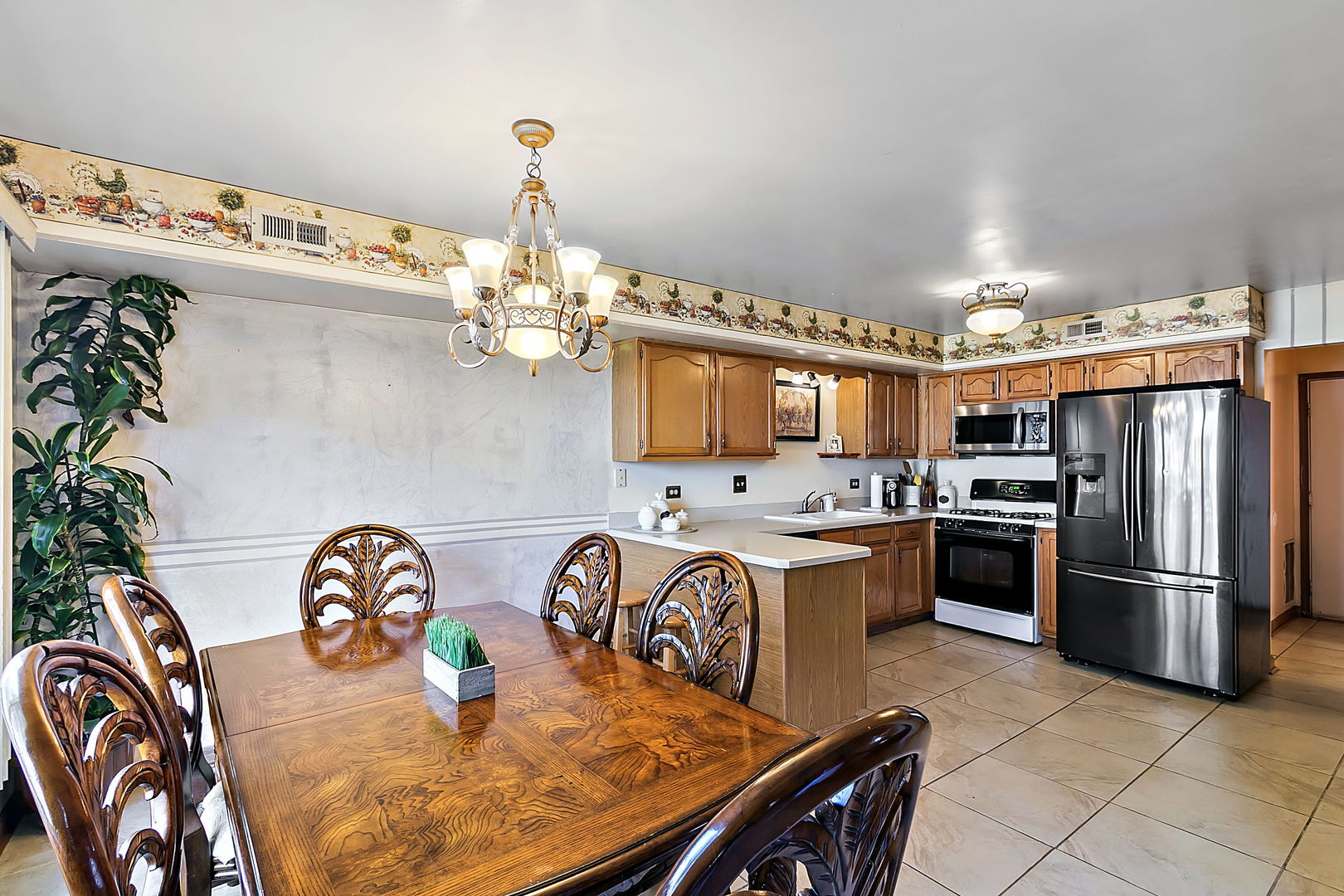 116 Hampton Avenue Westmont, IL 60559 - Photo 7 of 19 a kitchen with stainless steel appliances granite countertop a sink dishwasher stove a refrigerator with a dining table and chairs