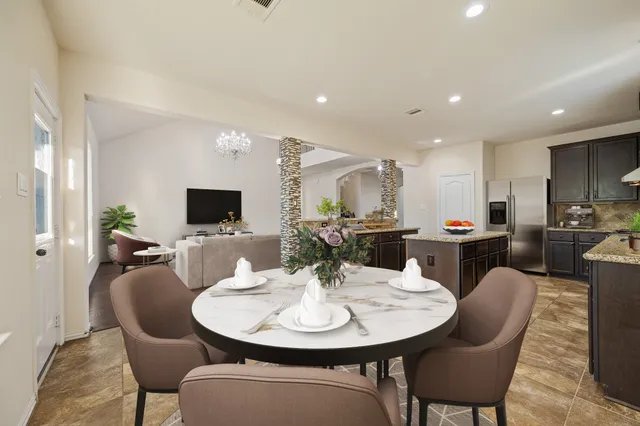 a bedroom with a large bed and a chandelier