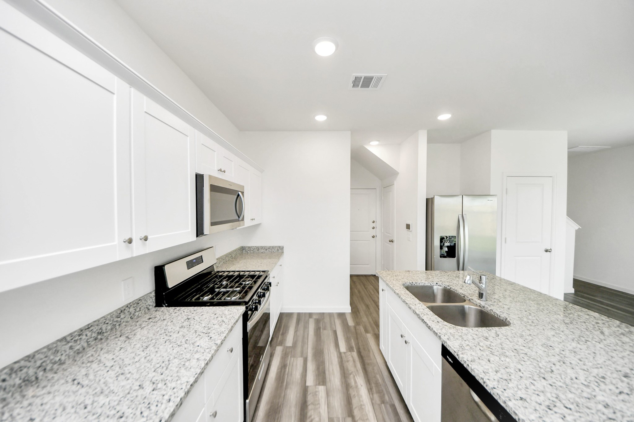 10303 Rose Mar Drive, Unit B Rosharon, TX 77583 - Photo 14 of 49 a large kitchen with a stove and a sink