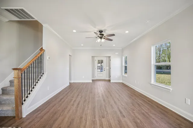 wooden floor in an empty room with a window