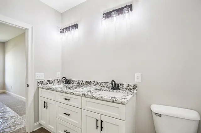 a bathroom with a white cabinet and a white door