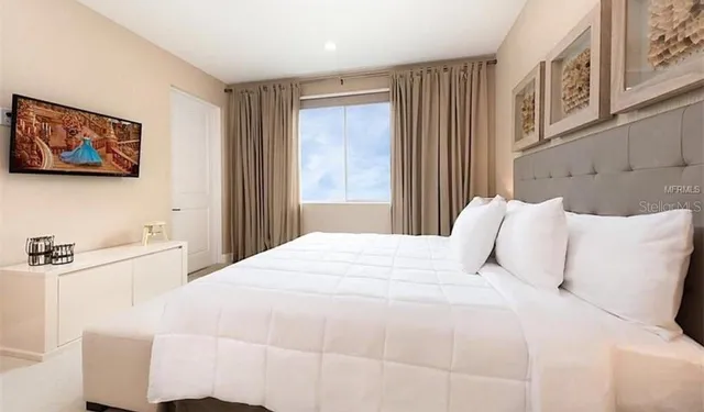 a bedroom with bed and window