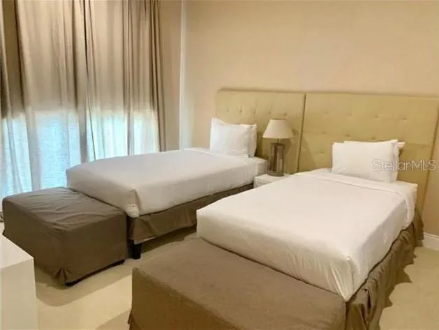 a bedroom with bed and window