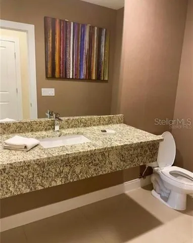 a large bed sitting in a bedroom next to a window