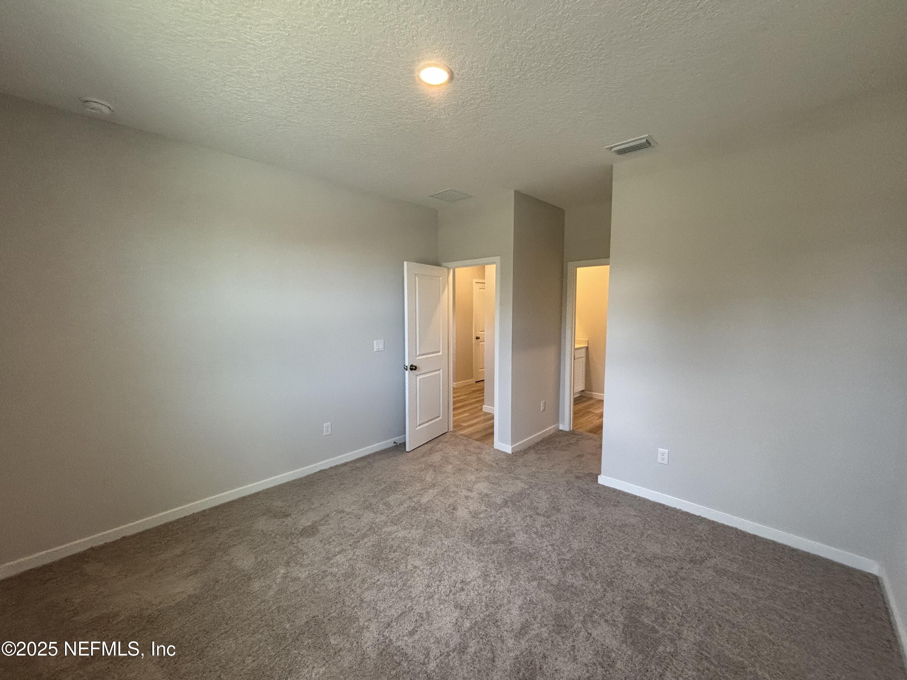 67 Pegasus Road Flagler Beach, FL 32136 - Photo 11 of 34 an empty room with windows and closet