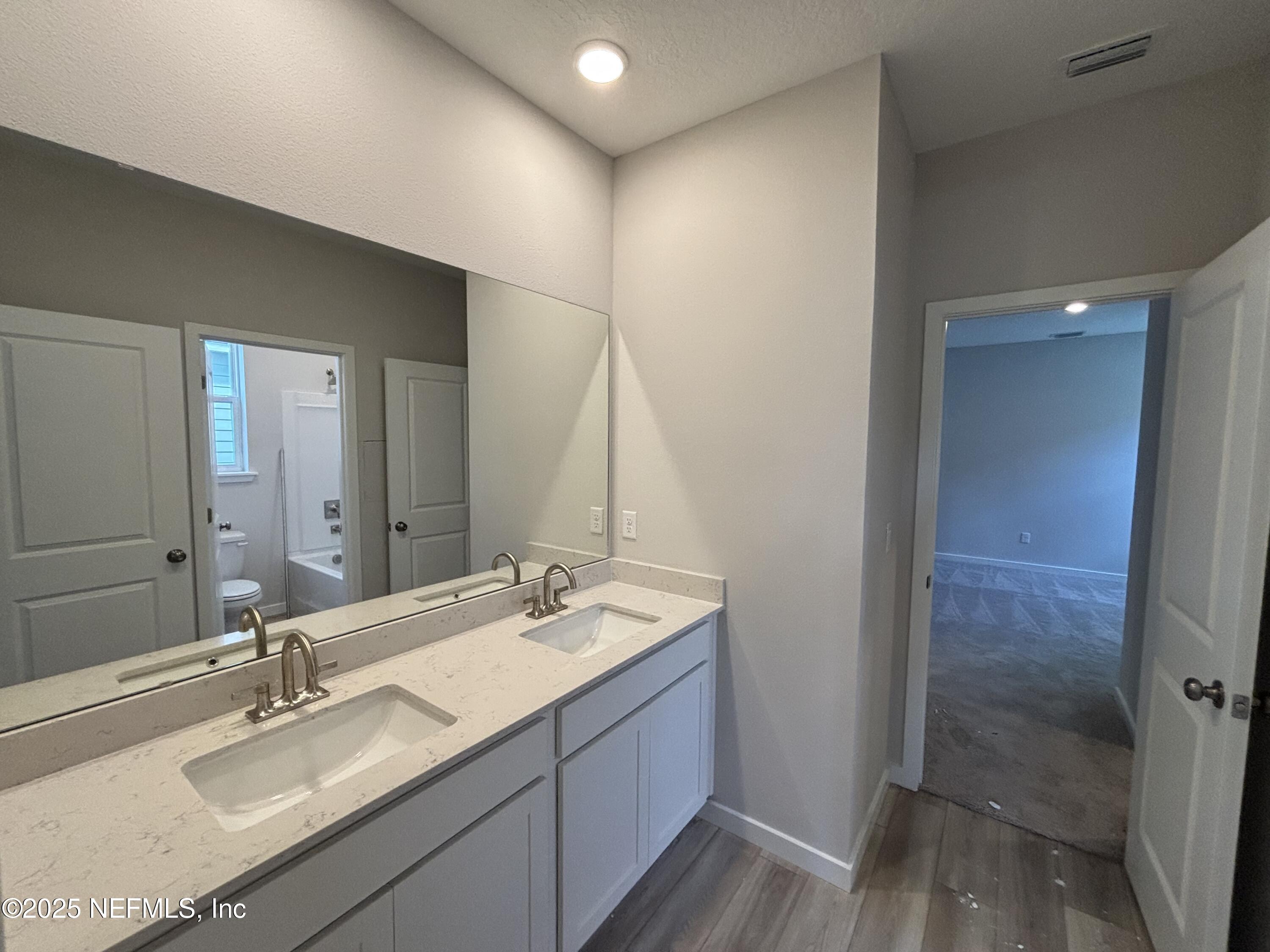 67 Pegasus Road Flagler Beach, FL 32136 - Photo 12 of 34 a bathroom with double vanity sink and a mirror