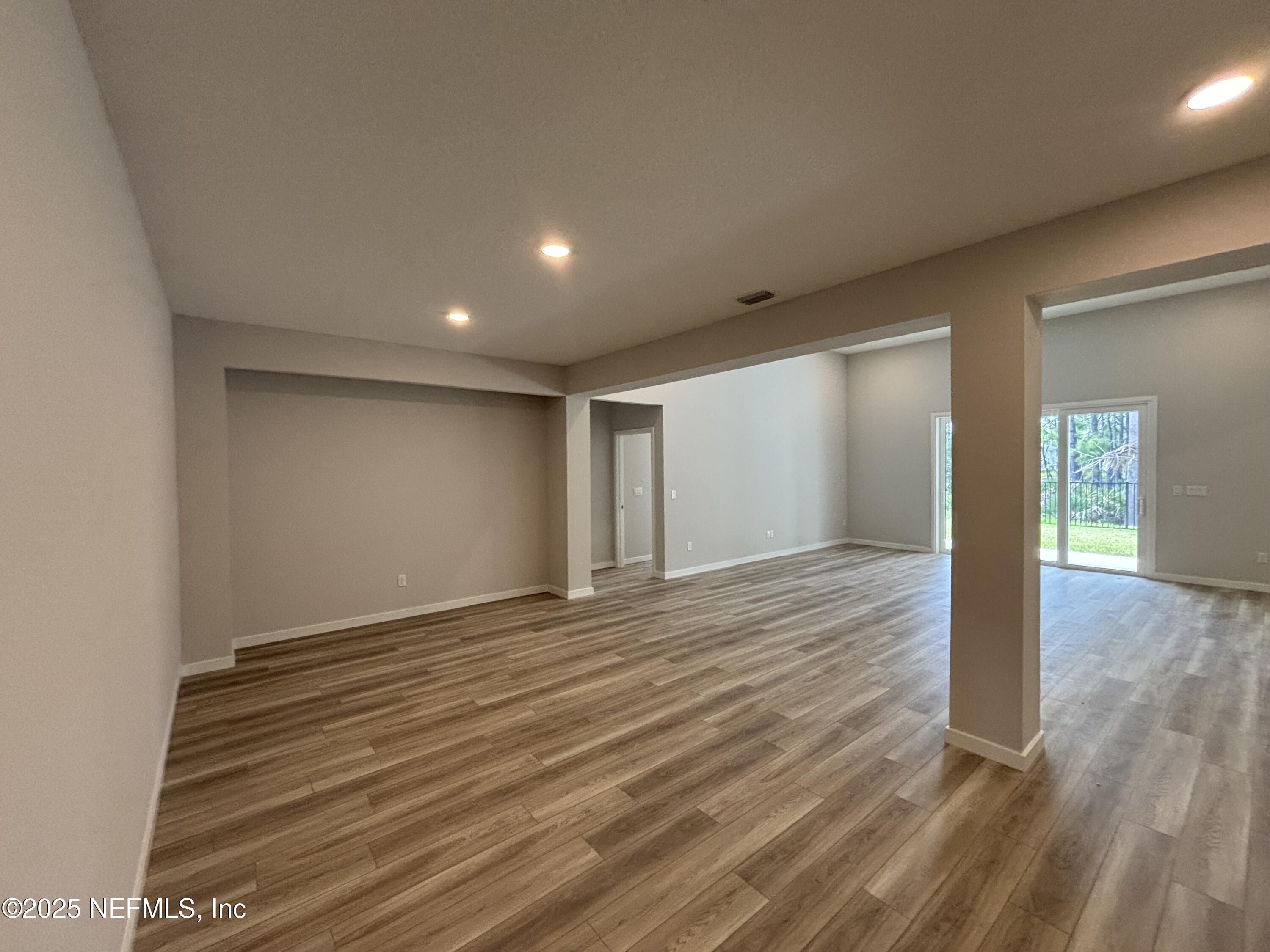 67 Pegasus Road Flagler Beach, FL 32136 - Photo 14 of 34 a view of an empty room with wooden floor and window