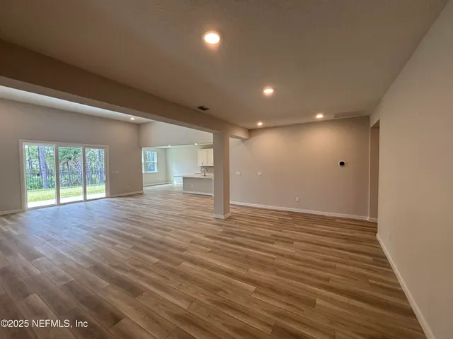 a view of kitchen with cabinets microwave and stove