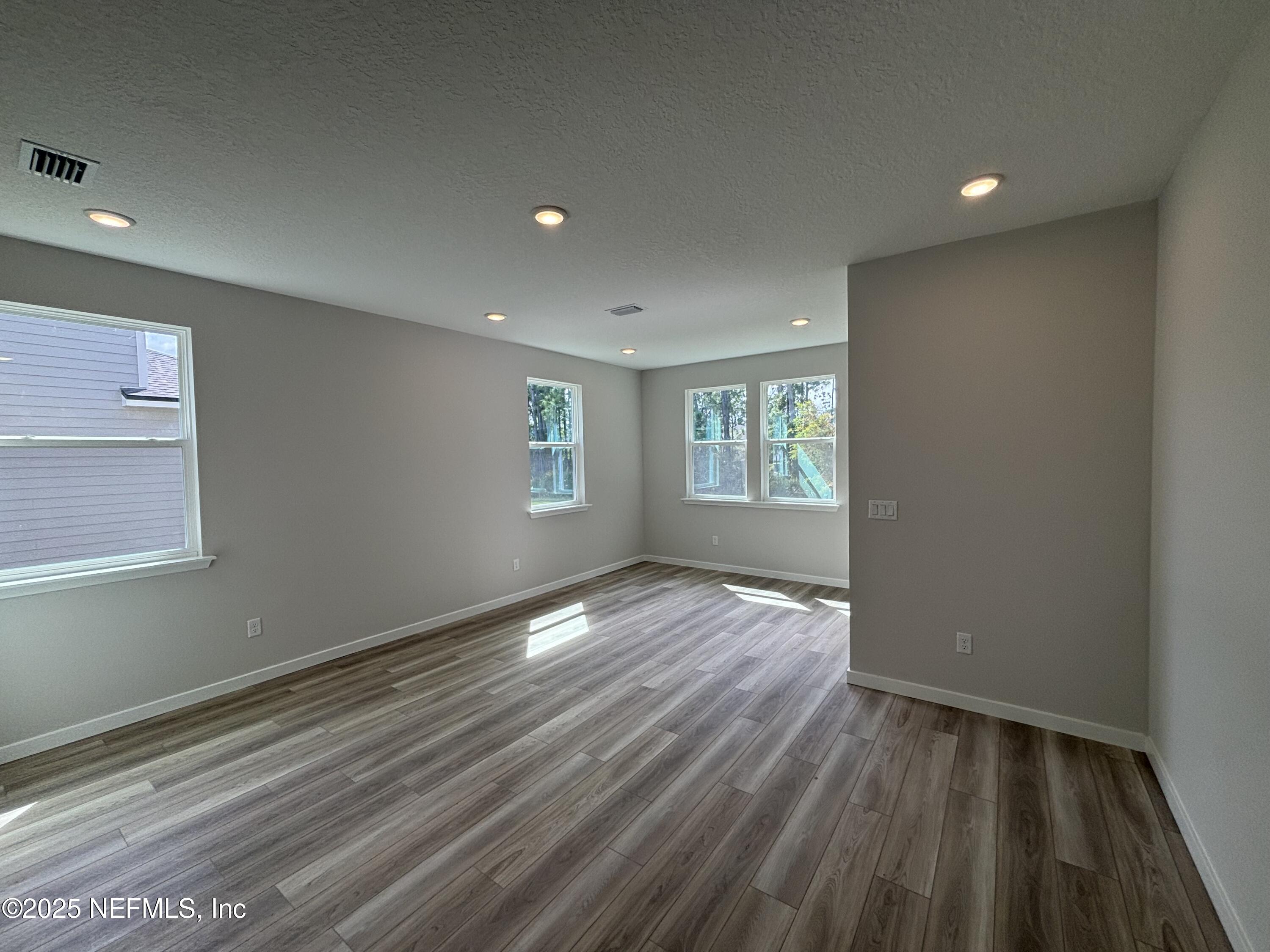 67 Pegasus Road Flagler Beach, FL 32136 - Photo 23 of 34 a view of an empty room with wooden floor and a window