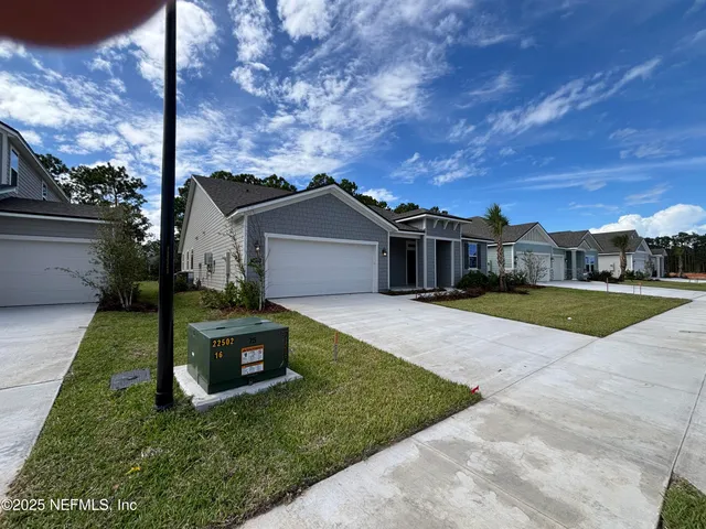 a view of a house with backyard and porch