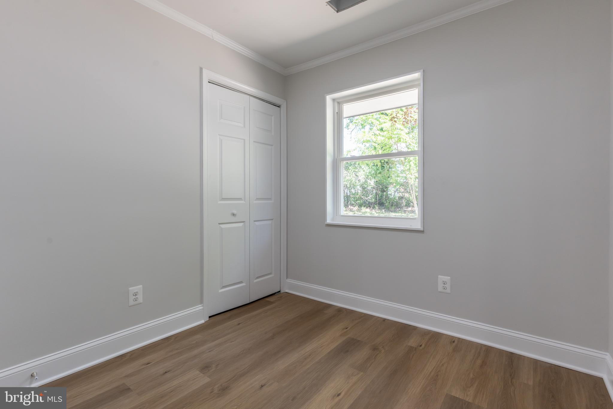 5506 Joplin Street Springfield, VA 22151 - Photo 12 of 32 an empty room with wooden floor and windows