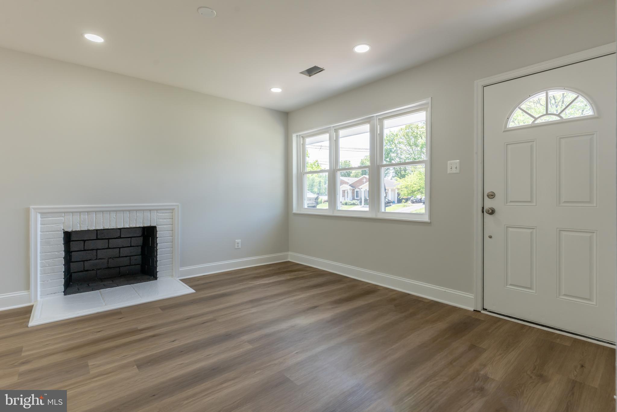 5506 Joplin Street Springfield, VA 22151 - Photo 19 of 32 an empty room with wooden floor fireplace and windows