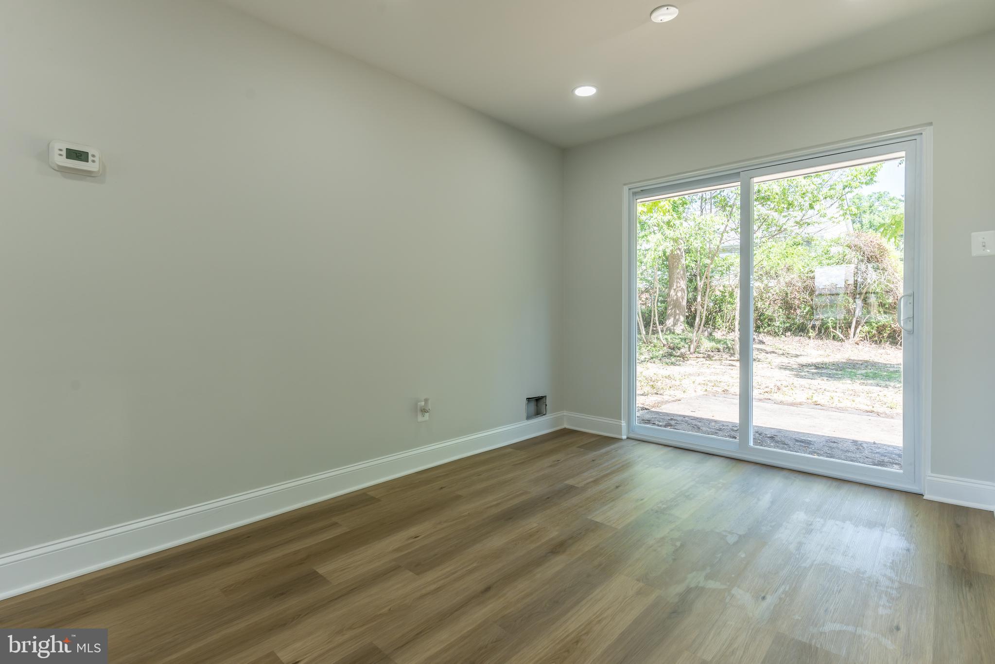 5506 Joplin Street Springfield, VA 22151 - Photo 2 of 32 a view of an empty room with wooden floor and a window
