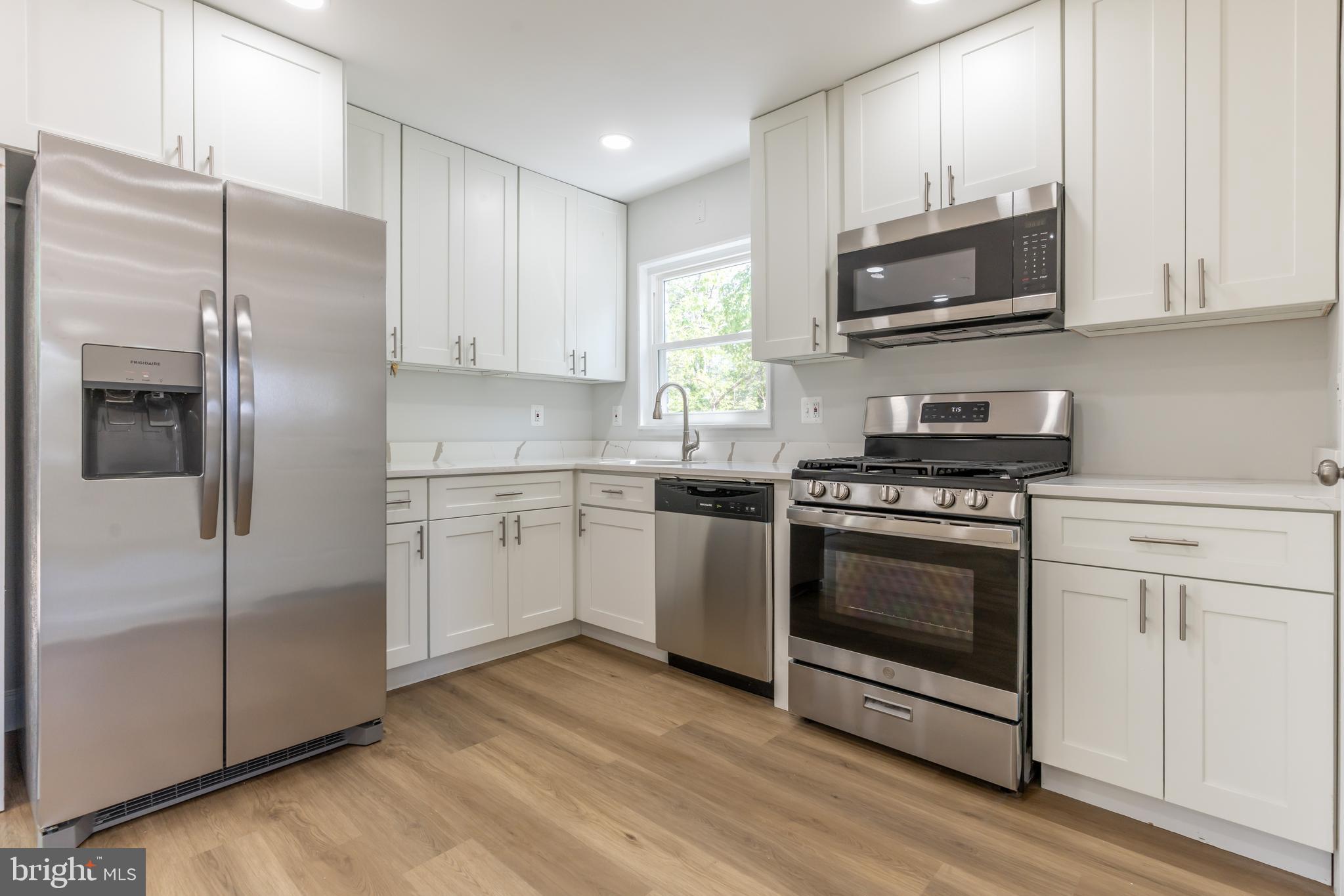 5506 Joplin Street Springfield, VA 22151 - Photo 5 of 32 a kitchen with cabinets stainless steel appliances and wooden floor