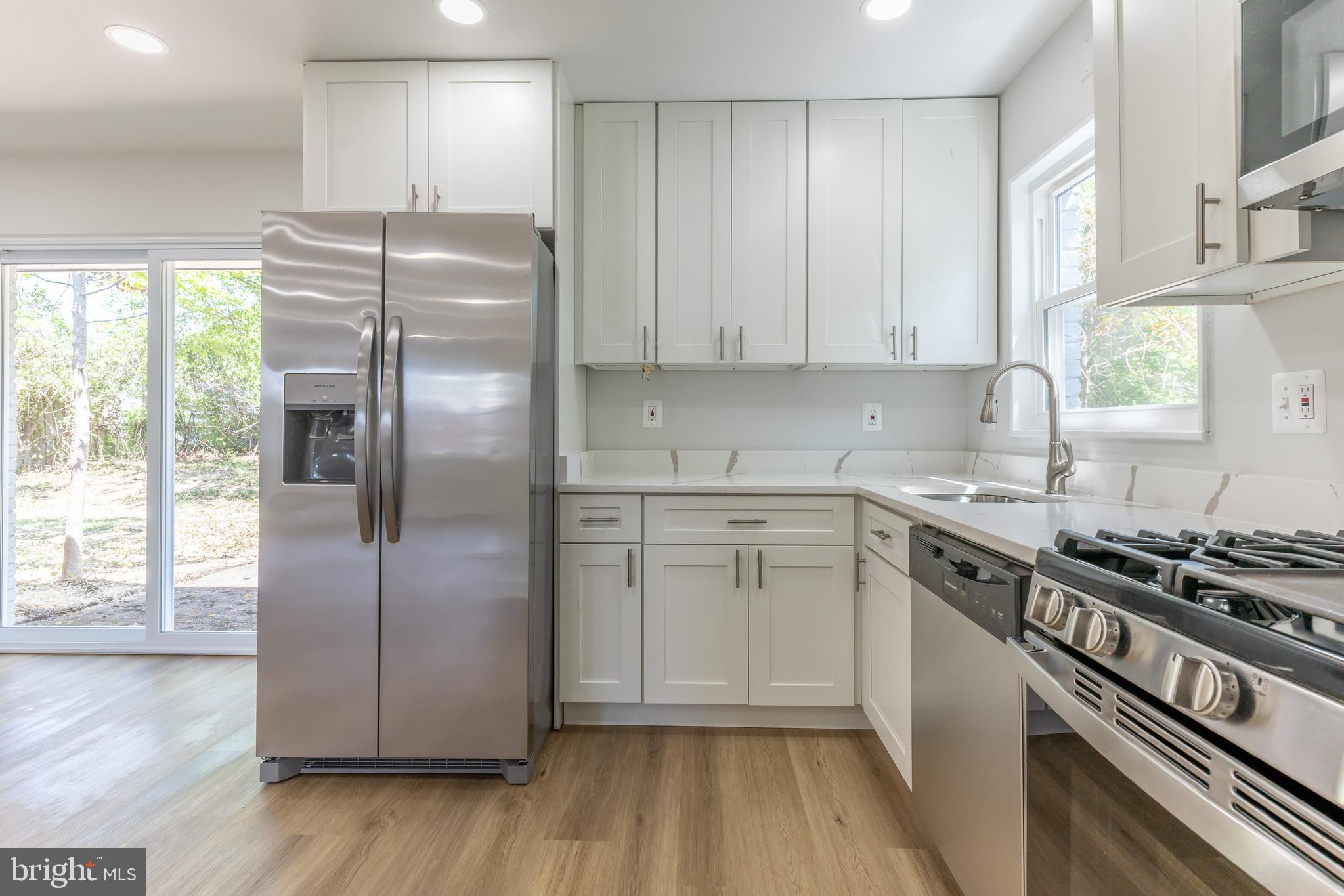 5506 Joplin Street Springfield, VA 22151 - Photo 6 of 32 a kitchen with a refrigerator a sink and cabinets