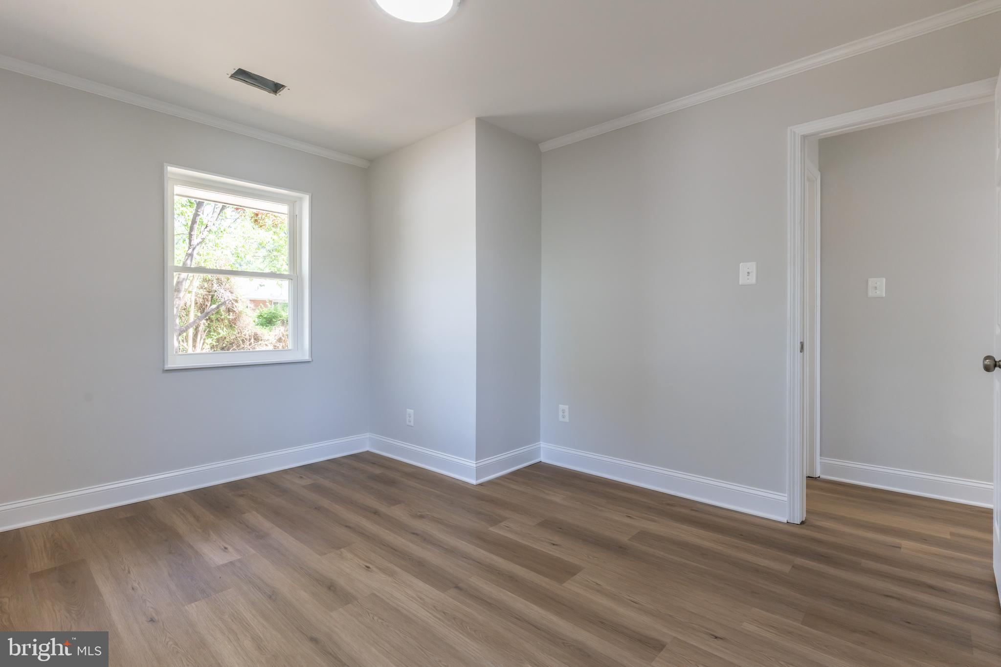5506 Joplin Street Springfield, VA 22151 - Photo 9 of 32 a view of an empty room with wooden floor and a window