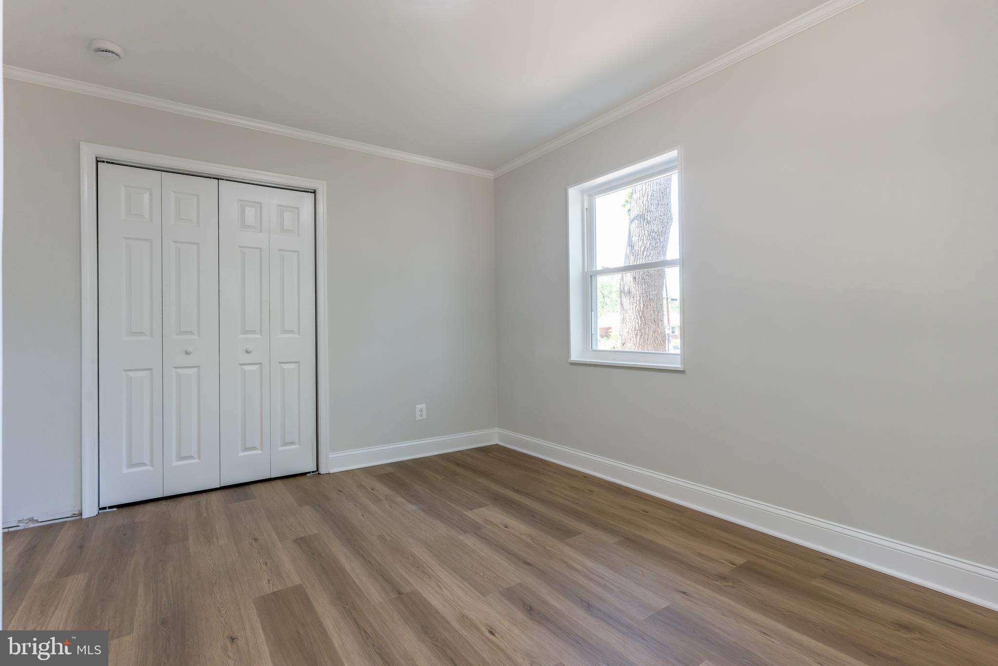 5506 Joplin Street Springfield, VA 22151 - Photo 10 of 32 an empty room with wooden floor and windows