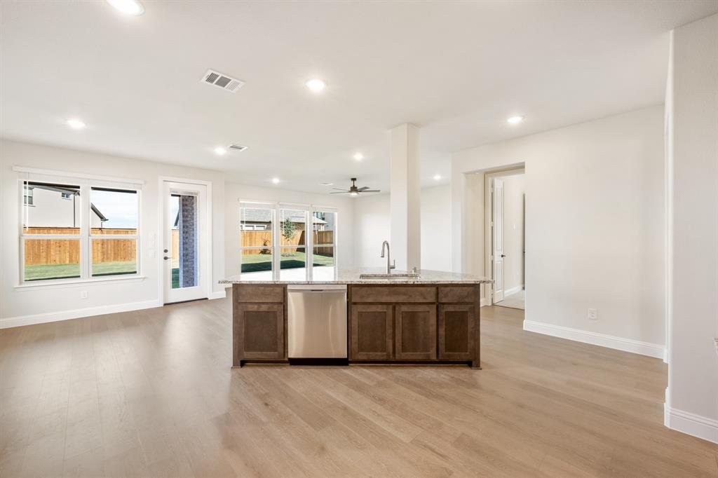 14422 McClint Street Pilot Point, TX 76258 - Photo 13 of 40 a large kitchen with a sink and a stove top oven