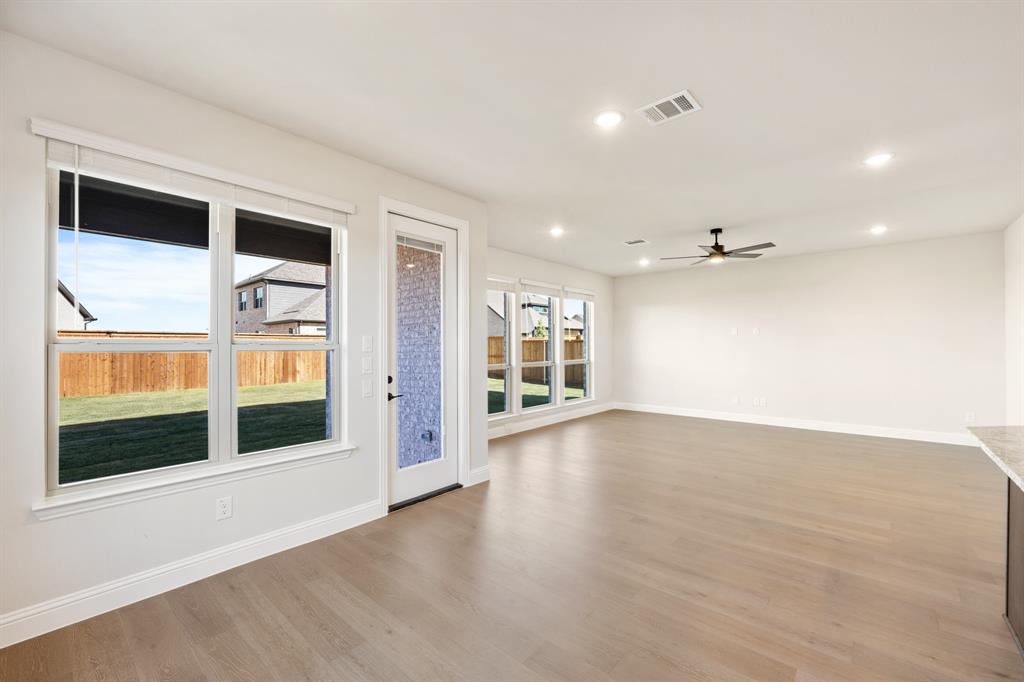 14422 McClint Street Pilot Point, TX 76258 - Photo 14 of 40 a view of an empty room with a window and wooden floor