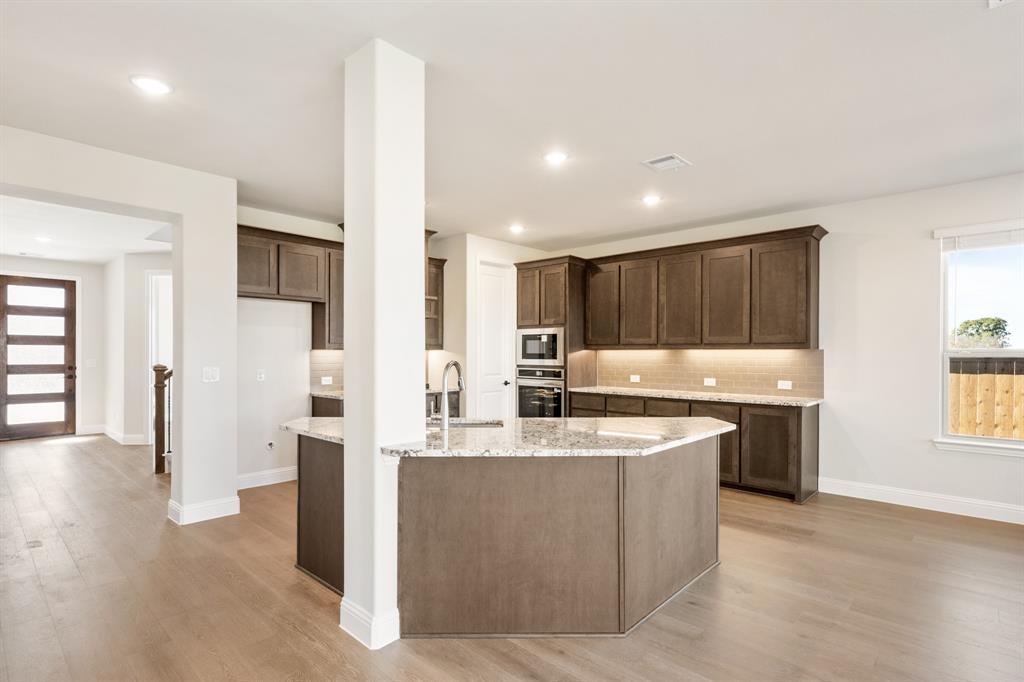 14422 McClint Street Pilot Point, TX 76258 - Photo 16 of 40 a kitchen with a sink and a refrigerator