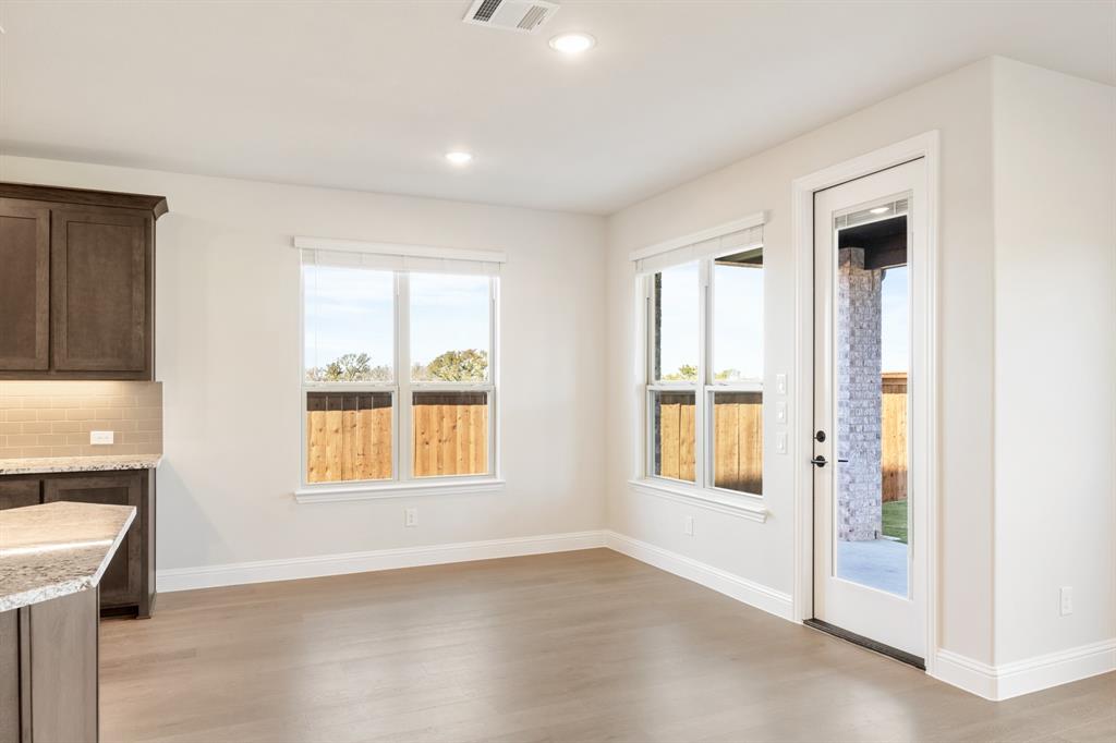 14422 McClint Street Pilot Point, TX 76258 - Photo 17 of 40 a view of an empty room with a window and wooden floor