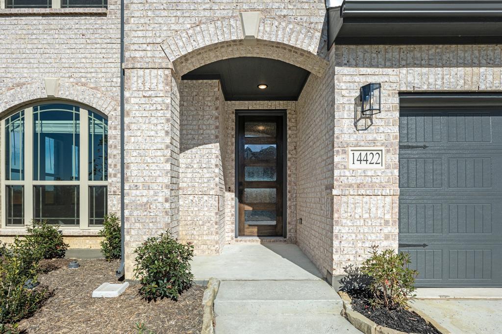 14422 McClint Street Pilot Point, TX 76258 - Photo 3 of 40 a front view of a house with potted plants