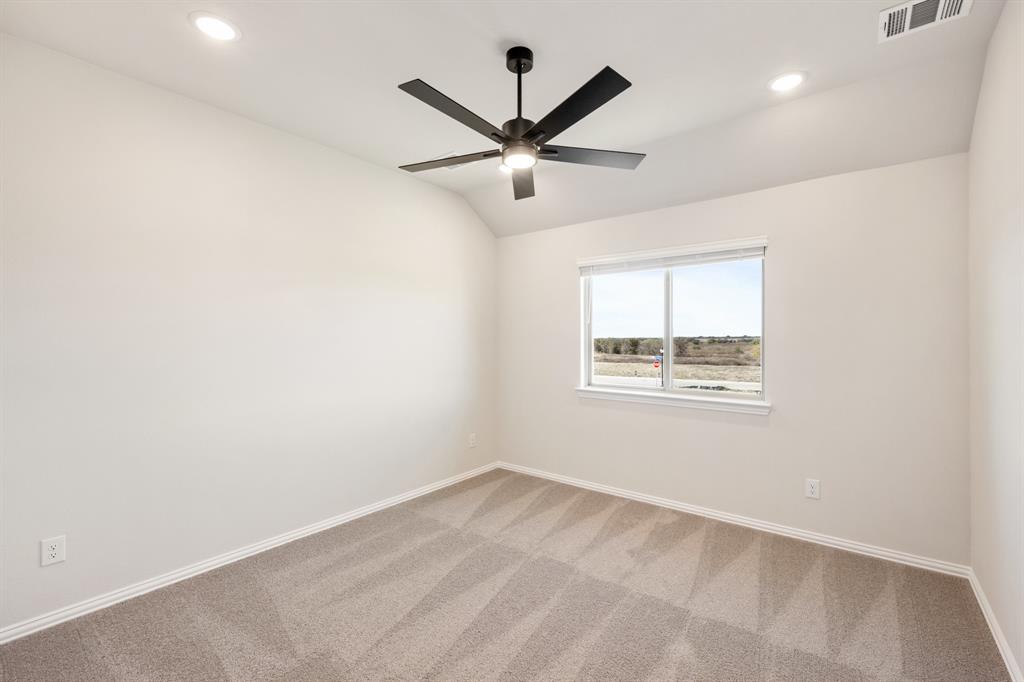 14422 McClint Street Pilot Point, TX 76258 - Photo 32 of 40 an empty room with a window and a ceiling fan