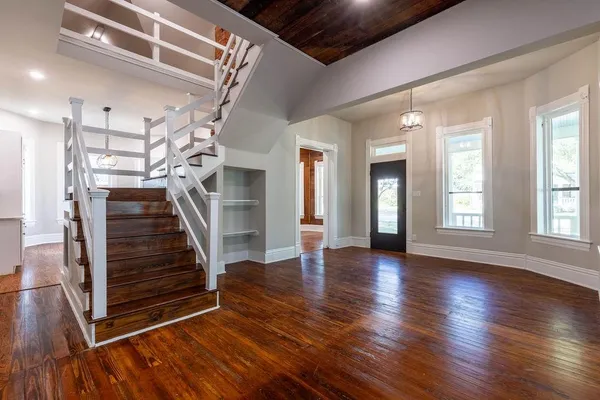 a view of entryway with stairs and wooden floor