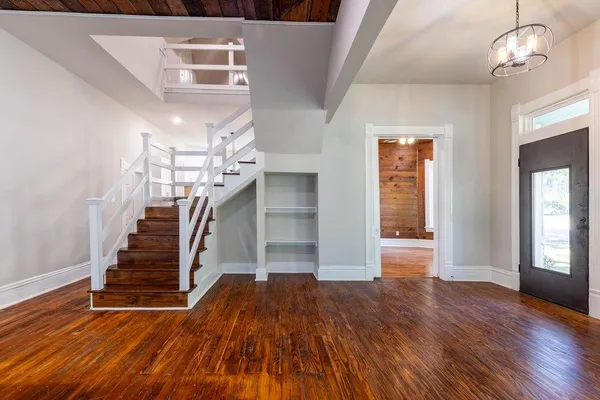 wooden floor in an empty room with a window