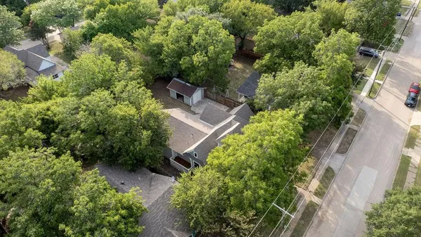 an aerial view of a house with outdoor space and street view