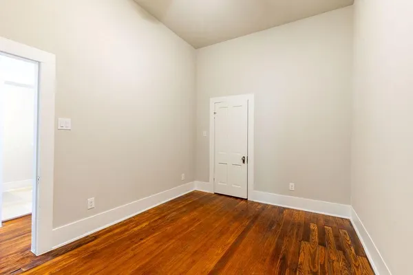 a view of a room with wooden floor