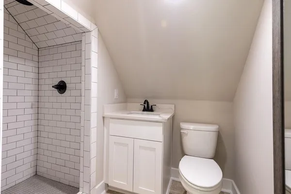 a bathroom with a toilet a sink and shower