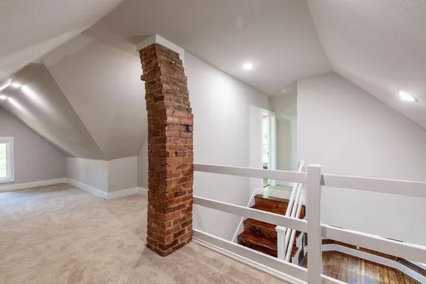 a view of an empty room with stairs and toys