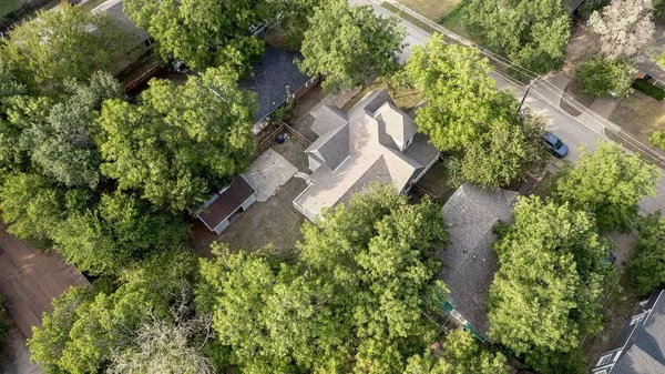 an aerial view of a house with a yard and garden