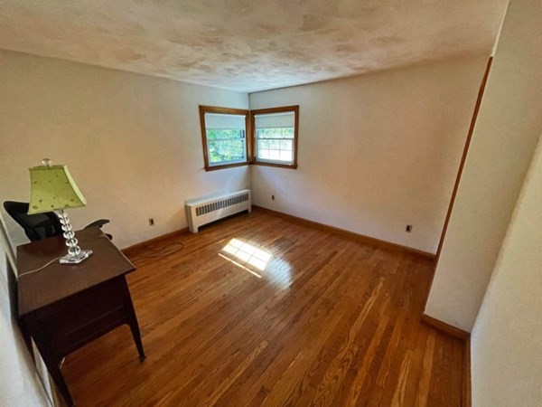 679 Westhampton Road Northampton, MA 01062 - Photo 4 of 11 a view of a workspace with wooden floor and a window