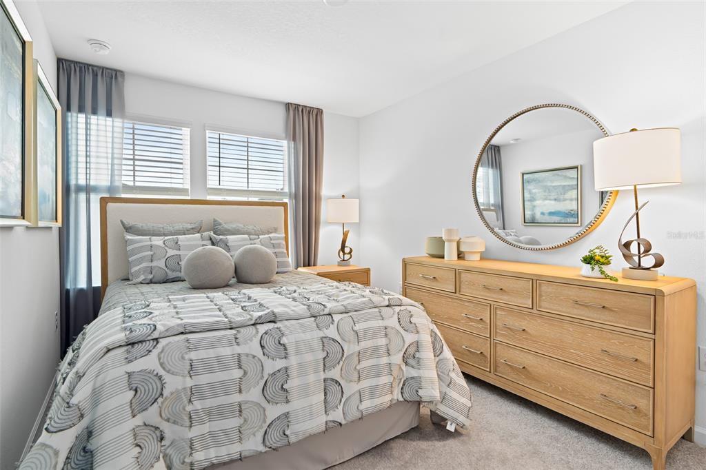 3639 Southeast 37th Ave Road Ocala, FL 34480 - Photo 11 of 61 a bedroom with a bed a mirror on dresser and a window