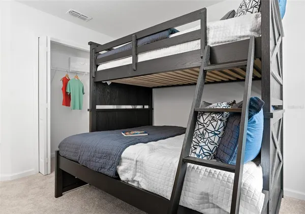 a bedroom with a bed and a dresser