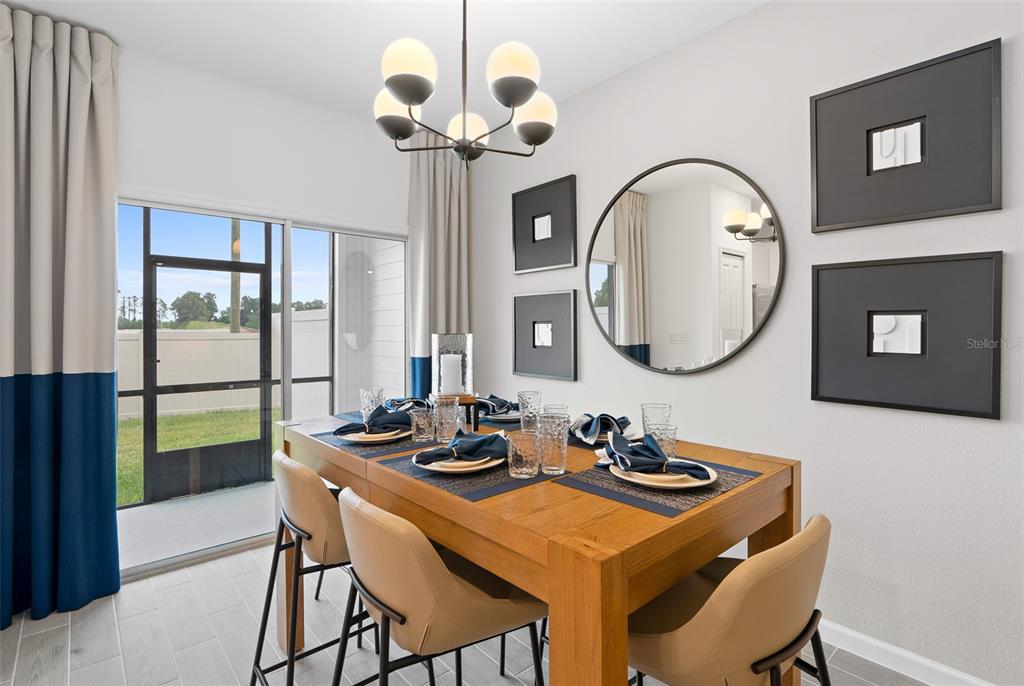 3639 Southeast 37th Ave Road Ocala, FL 34480 - Photo 17 of 61 a dining room with wooden floor a chandelier a wooden table and chairs