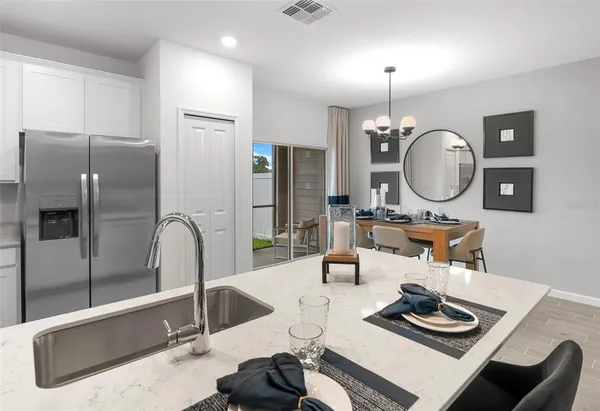 a kitchen with stainless steel appliances granite countertop a refrigerator sink and stove