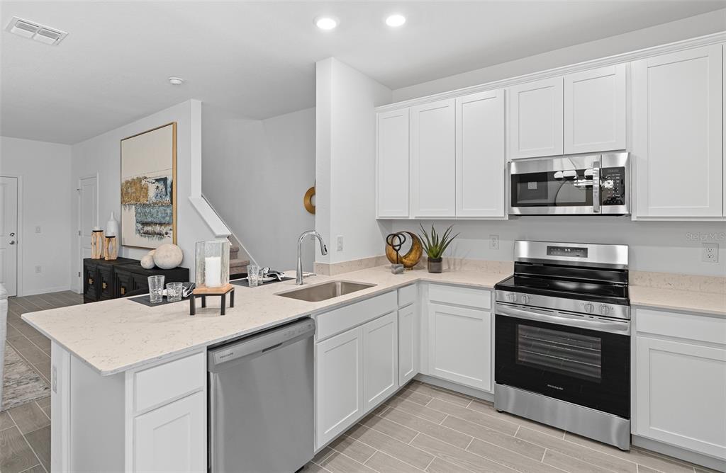 3639 Southeast 37th Ave Road Ocala, FL 34480 - Photo 20 of 61 a kitchen with a sink stove and cabinets