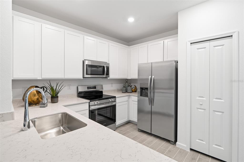 3639 Southeast 37th Ave Road Ocala, FL 34480 - Photo 21 of 61 a kitchen with stainless steel appliances granite countertop a refrigerator and a stove top oven