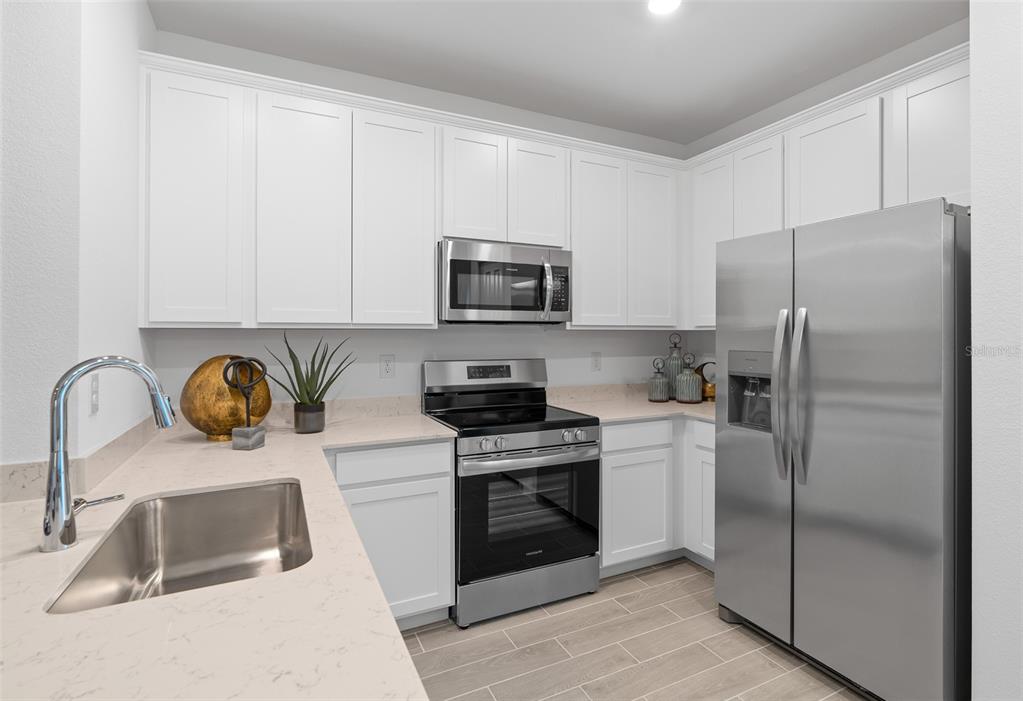 3639 Southeast 37th Ave Road Ocala, FL 34480 - Photo 22 of 61 a kitchen with stainless steel appliances granite countertop a refrigerator sink and stove