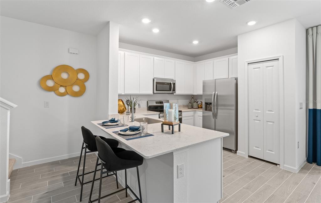 3639 Southeast 37th Ave Road Ocala, FL 34480 - Photo 28 of 61 a kitchen that has a table and chairs in it