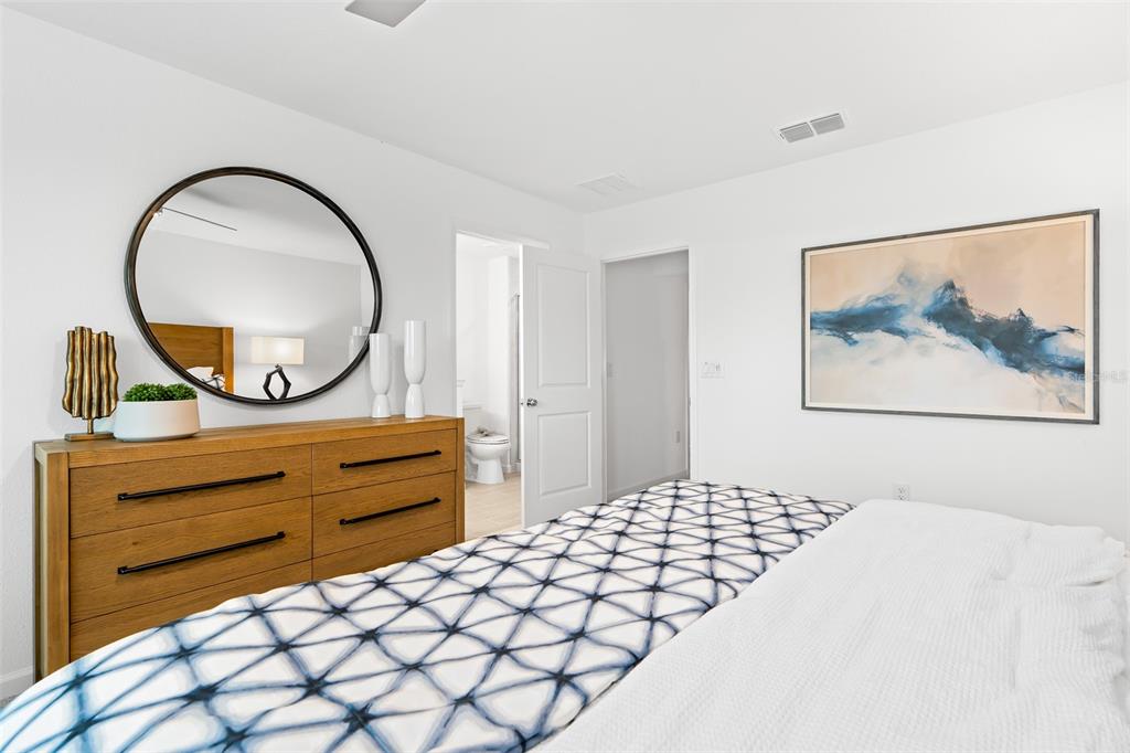 3639 Southeast 37th Ave Road Ocala, FL 34480 - Photo 32 of 61 a bedroom with a bed and a painting on the wall