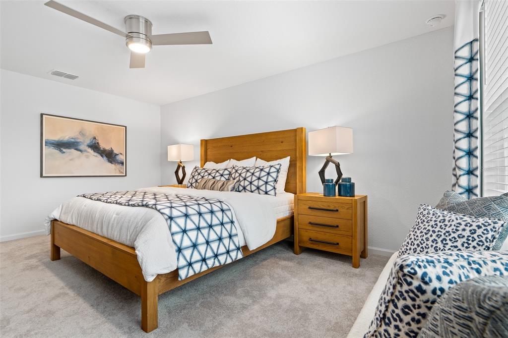 3639 Southeast 37th Ave Road Ocala, FL 34480 - Photo 33 of 61 a bedroom with a bed and a painting on the wall