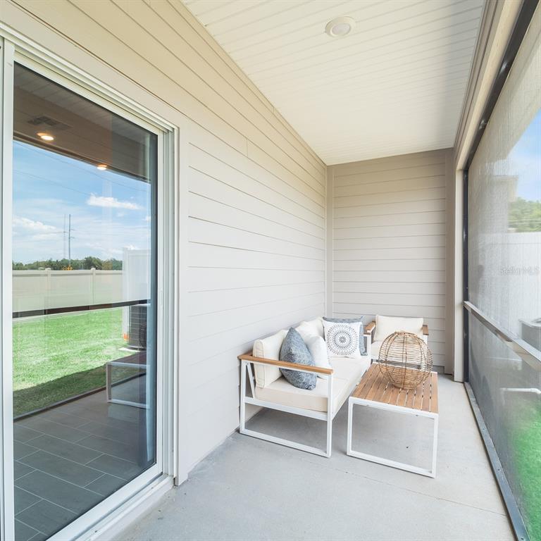3639 Southeast 37th Ave Road Ocala, FL 34480 - Photo 4 of 61 a living room with furniture and a floor to ceiling window