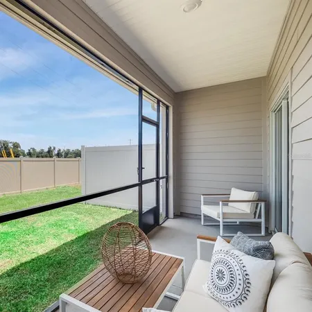 a view of house with yard and outdoor seating