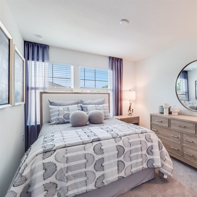 3639 Southeast 37th Ave Road Ocala, FL 34480 - Photo 52 of 61 a bedroom with a large bed and a window